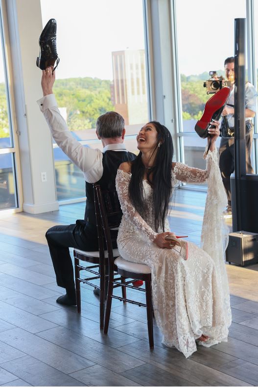 Bride and groom playing the shoe game at their reception