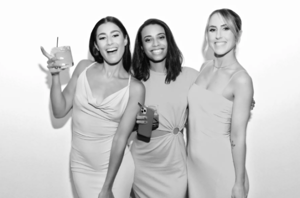 Guests laughing inside an open-air photo booth