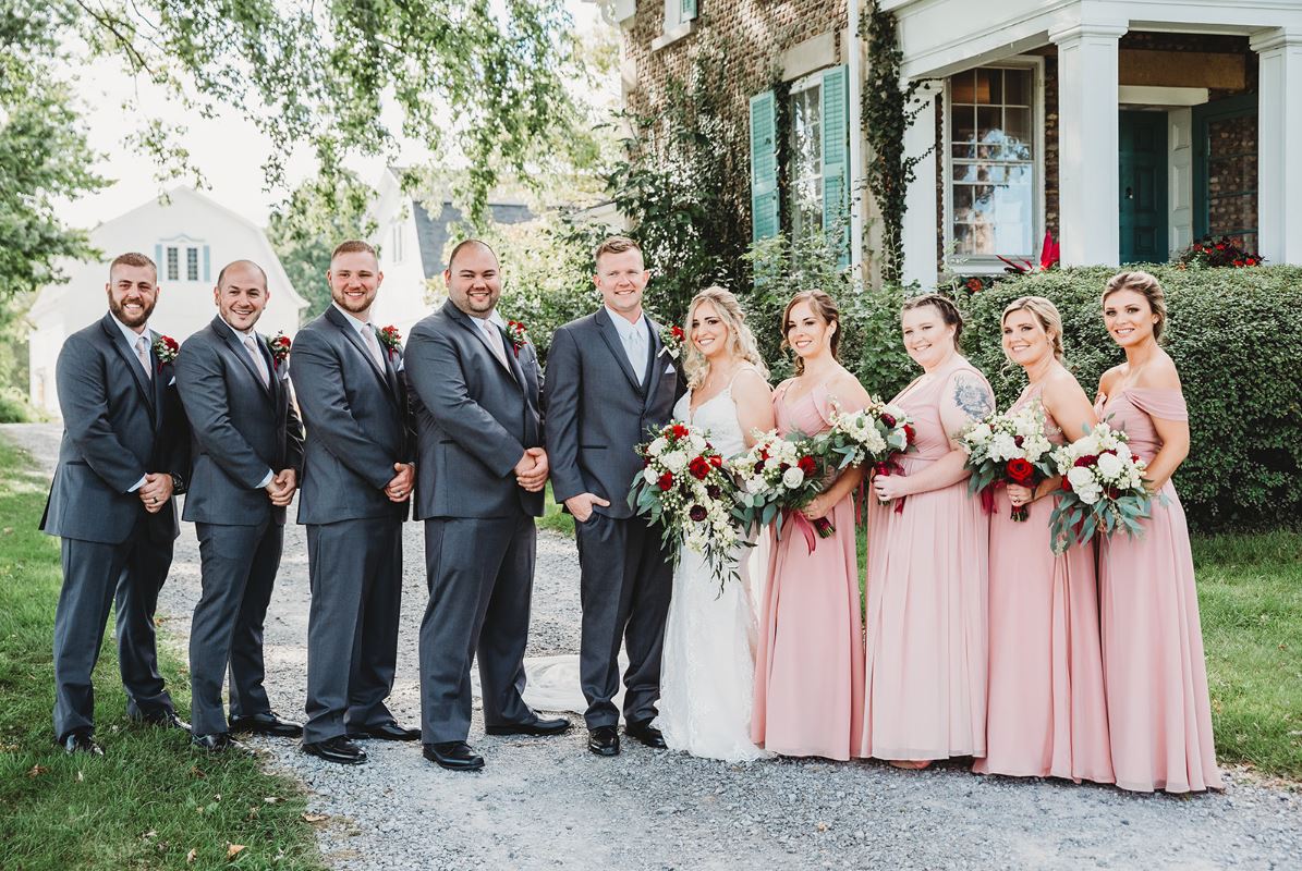 Full bridal party portrait outside a historic home