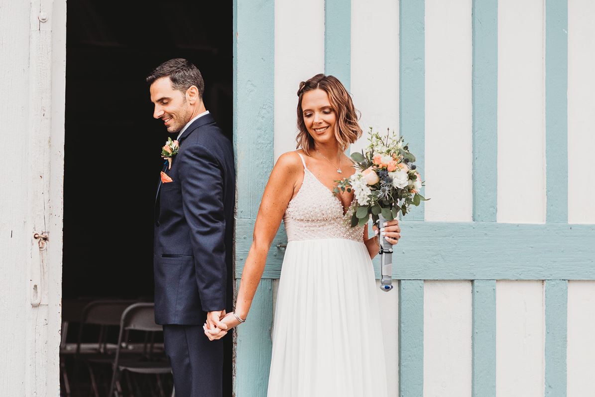 Bride and groom back to back for a first look moment