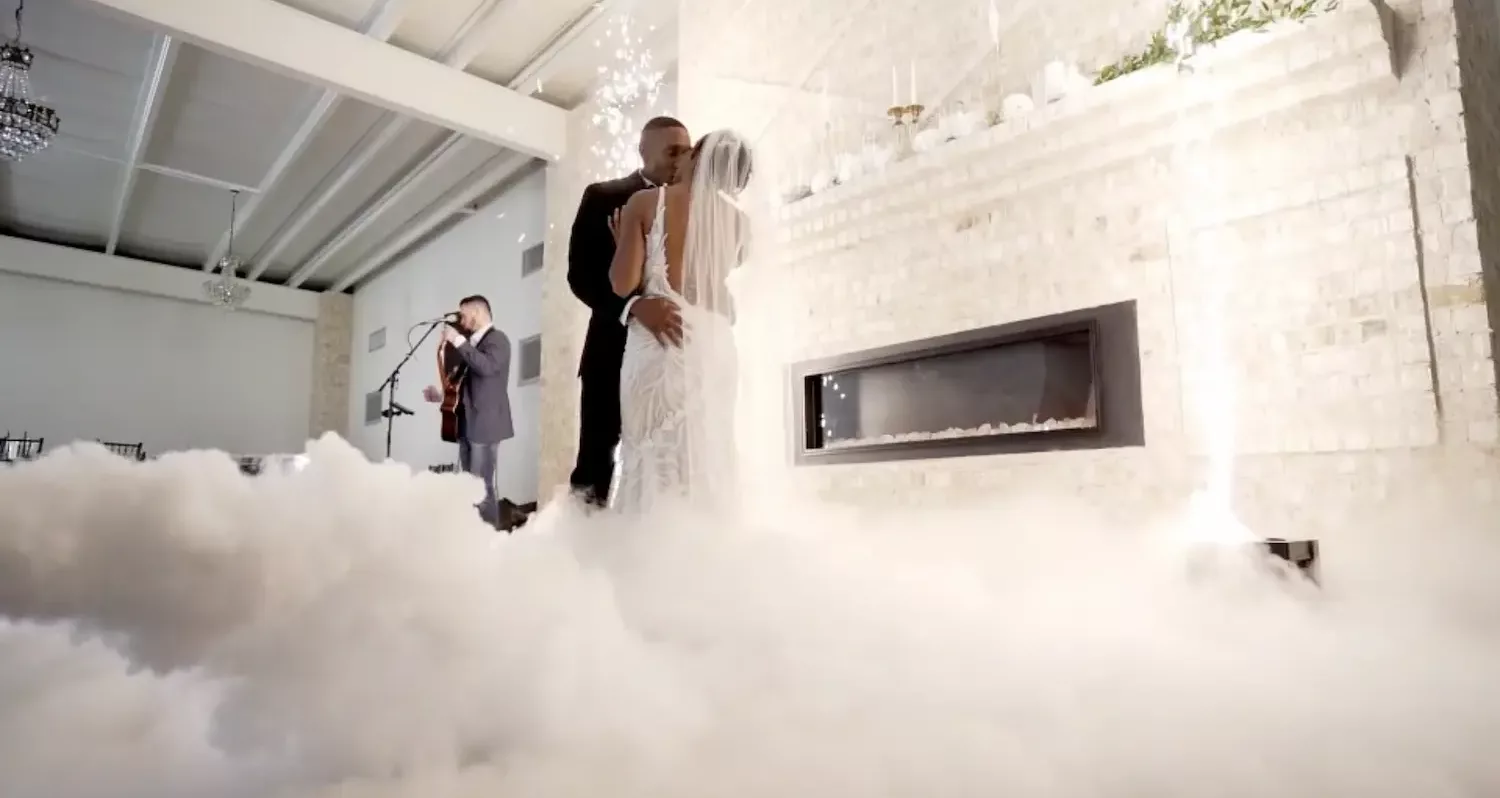 Bride and groom's first dance on a cloud of low fog
