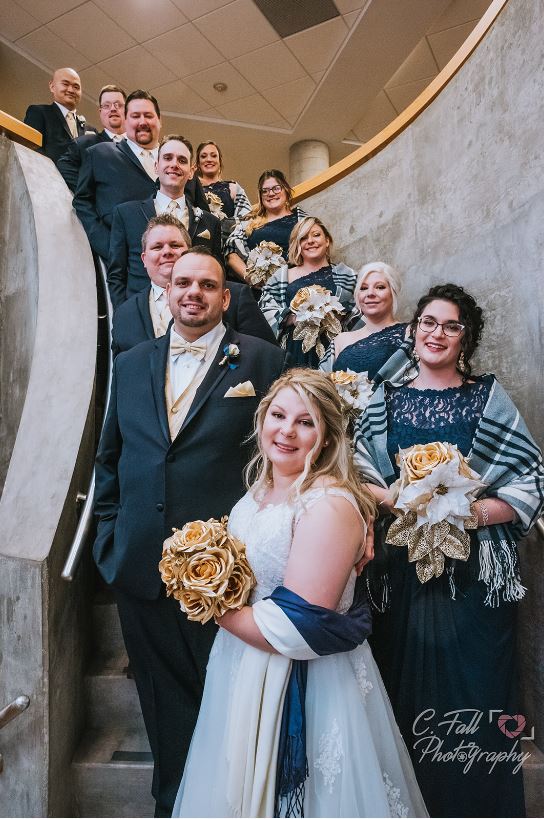 Wedding party posed on a spiral staircase