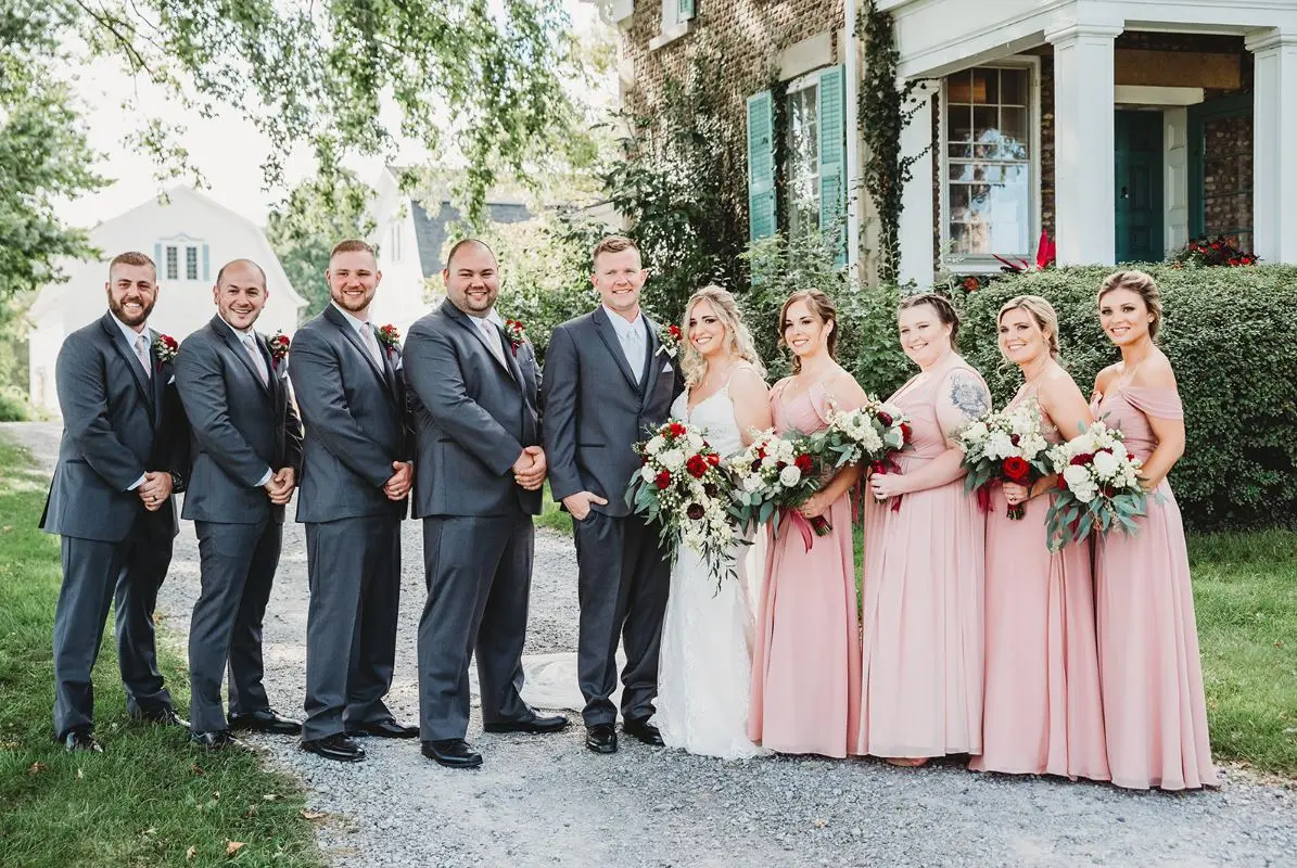 Full bridal party portrait outside a historic home